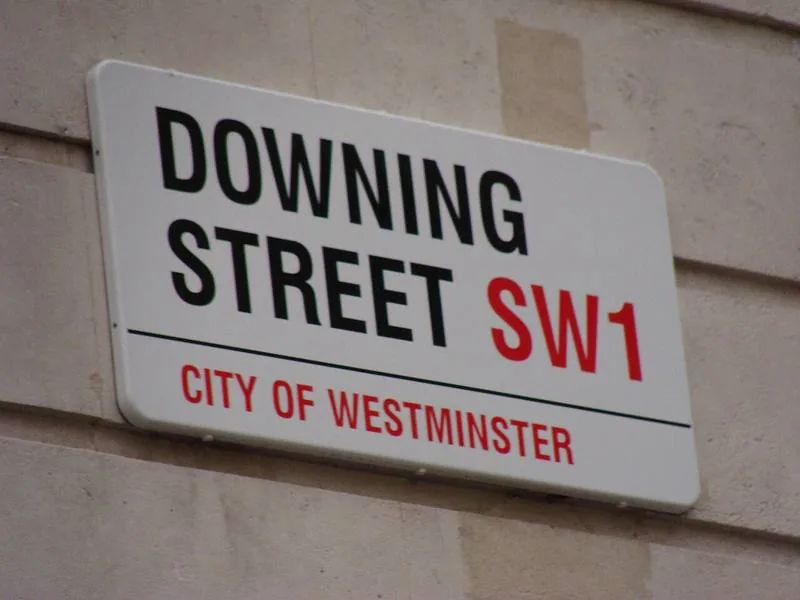 A street sign reading Downing Street SW1, City of Westminster
