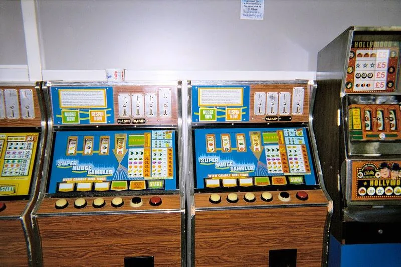 Three UK fruit machines in an amusement arcade