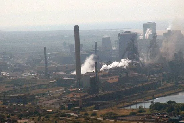 Port Talbot steelworks seen from a distance with smoke rising